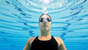 woman exhales under water