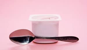 yogurt container on pink background