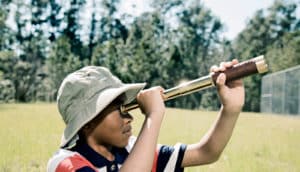 kid using telescope