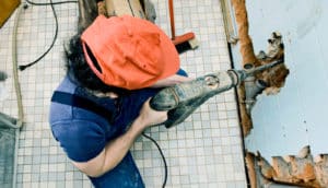 man drilling through wall