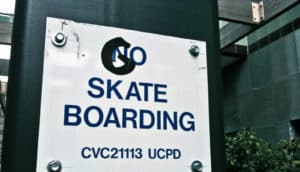 vandalized "no skateboarding" sign