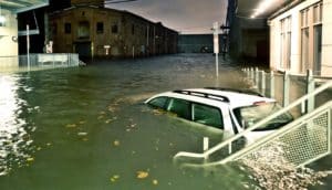 car underwater on flooded street