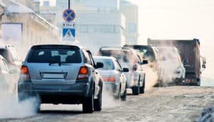 cars in traffic with visible exhaust