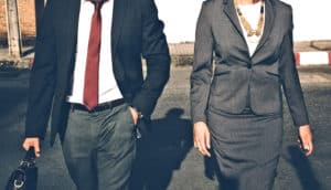 man and woman in suits walking