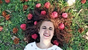 young on ground with flowers in hair - hay fever