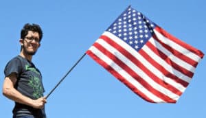 guy holds american flag - declaration of independence