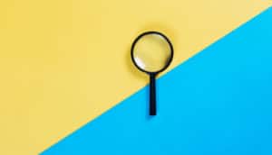 magnifying glass on blue and yellow background