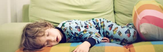 child sleeping on colorful couch - child snoring