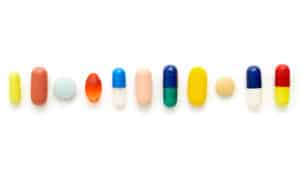 line of pills on white