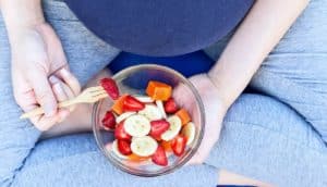 pregnant woman eating fruit