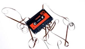 cassette tape unspooled on white background