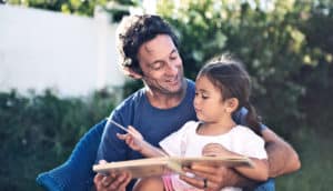 dad and daughter reading together