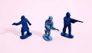 blue toy soldiers on pink (antibiotics concept)