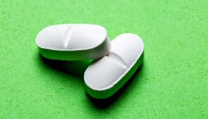 two pills on green