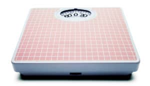 pink bathroom scale on white