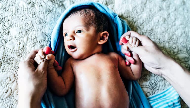 baby on blanket with mom (preterm births concept)