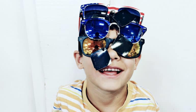 boy wears many pairs of sunglasses - flexible thinking