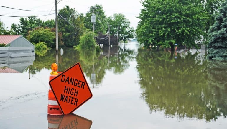 "danger high water" sign in flood