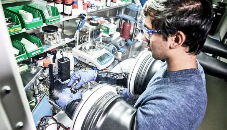 Dhruv Prakash works in a laboratory focused on battery research (solid-state batteries concept)