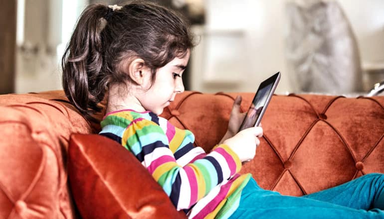 young girl with tablet (screen time concept)