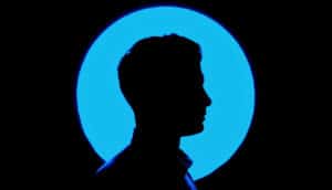 A silhouette of a man's head is surrounded by blue light. (ultrasound concept)