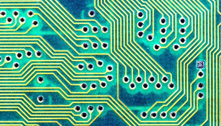 biological circuitry concept: yellow "pathways" on green circuit board