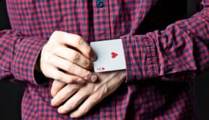 man with card up sleeve (cheating concept)