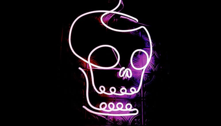 pink neon skull on black background