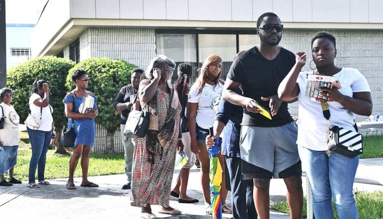 Voters stand outside in a line for early voting