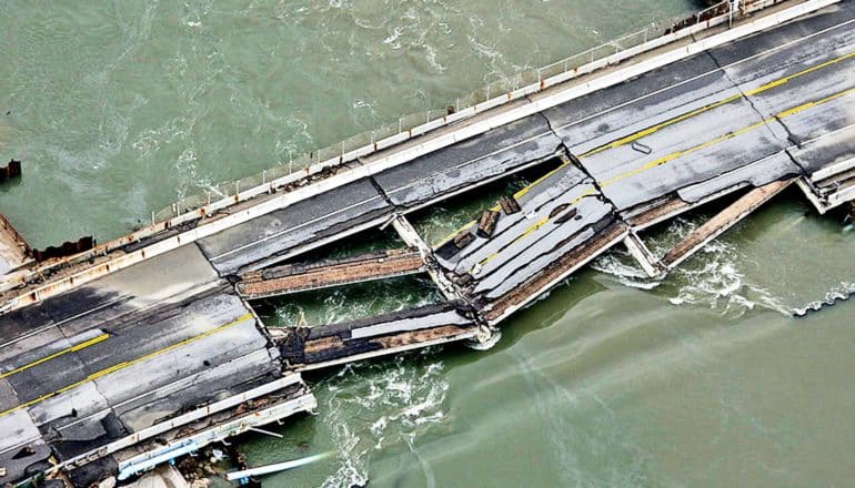 collapsed bridge spans water