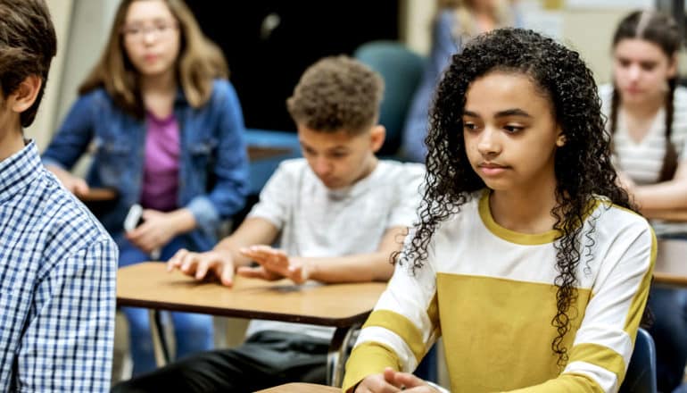 teens in classroom look a bit awkward