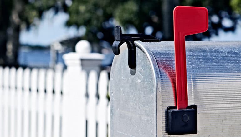 A mailbox has its flag up