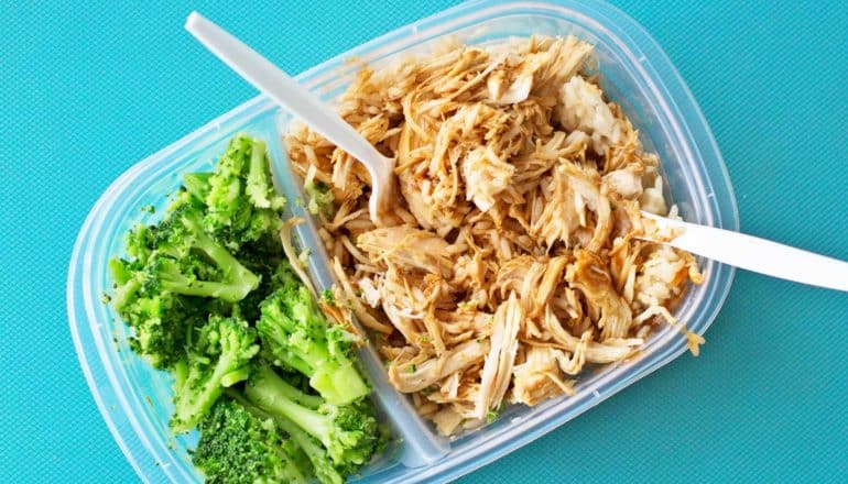 pulled meat and broccoli in tupperware container