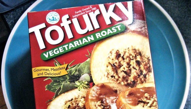 A red box of Tofurkey sits on a blue plate