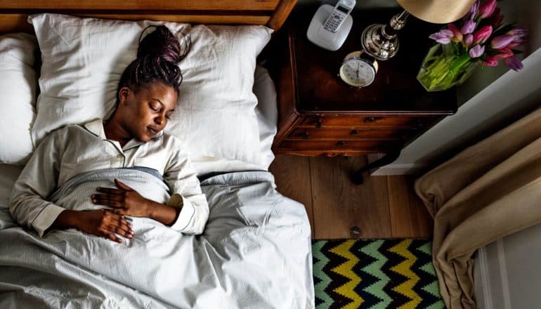 person asleep in bed from above