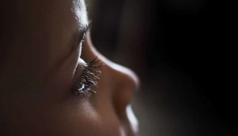 eye and nose of child in dark room