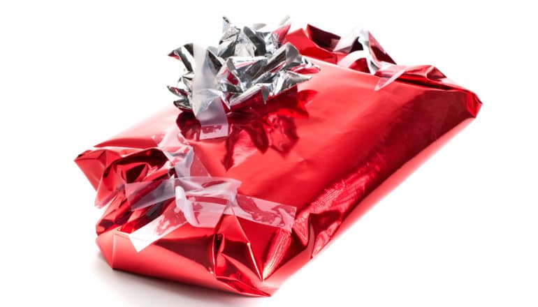 shiny red wrapping paper on gift with messy bow and tape