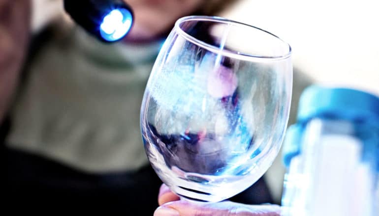 light shines on fingerprints on wine glass