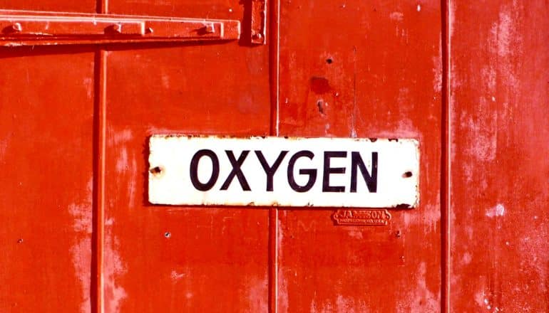 sign on red door says "oxygen"