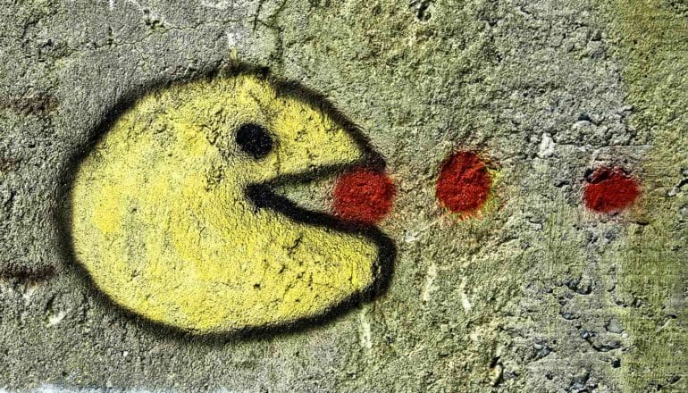 A graffiti version of PacMan gobbles red pellets