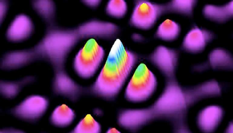 Colorful spikes against a black background show where a phosphorus atom is located in a silicon lattice