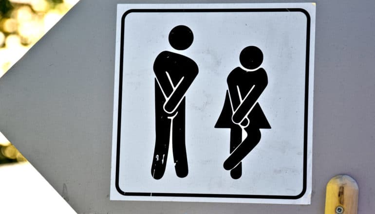 figures on bathroom sign look like they need to pee