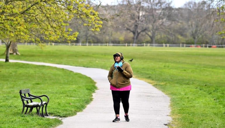 person walks on path in park