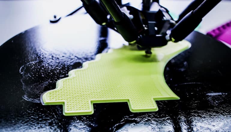 3D printer creates dino-shape in green