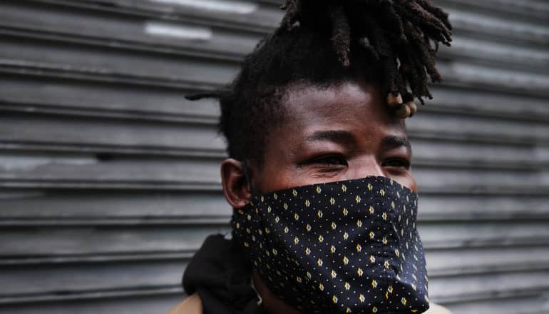 black man wearing homemade mask over mouth and nose