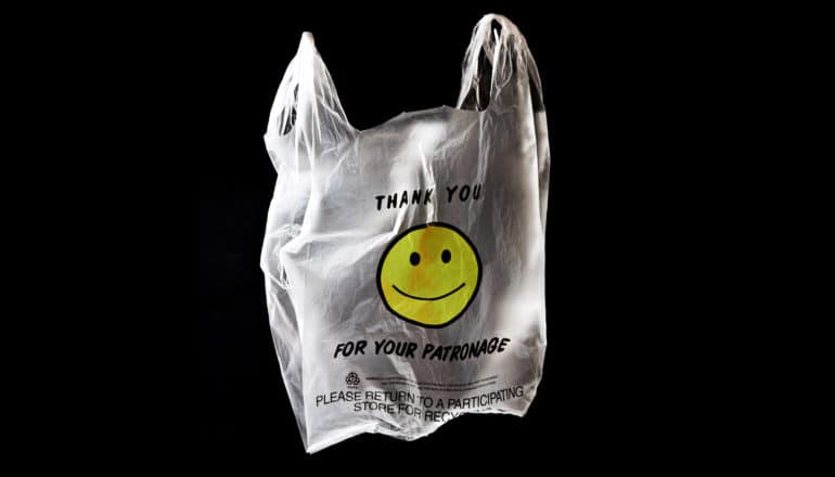 "thank you for shopping" smiley face plastic bag on black