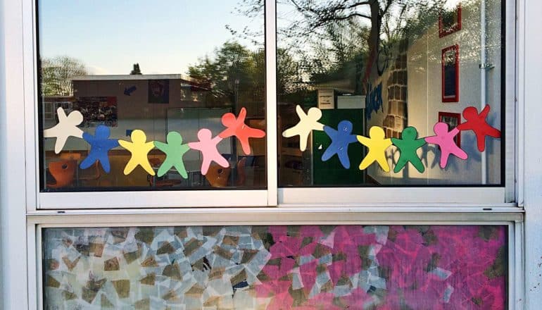 paper dolls on window