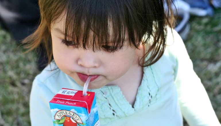 toddler drinks juice box