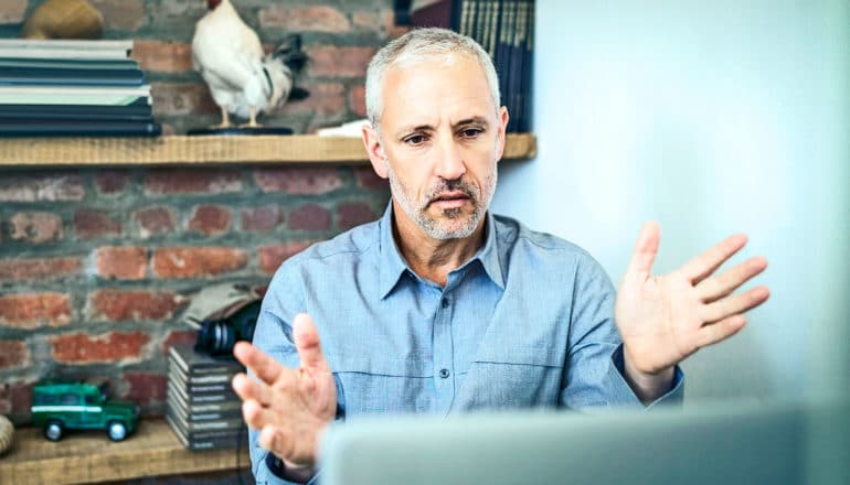 A counselor speaks to a client via video chat online