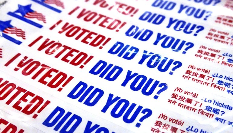 White wristbands have red and blue text that reads, "I voted! Did you?"